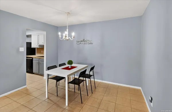 a view of a dining room with furniture and chandelier