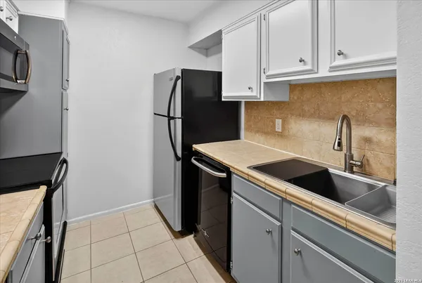a kitchen with a sink and refrigerator