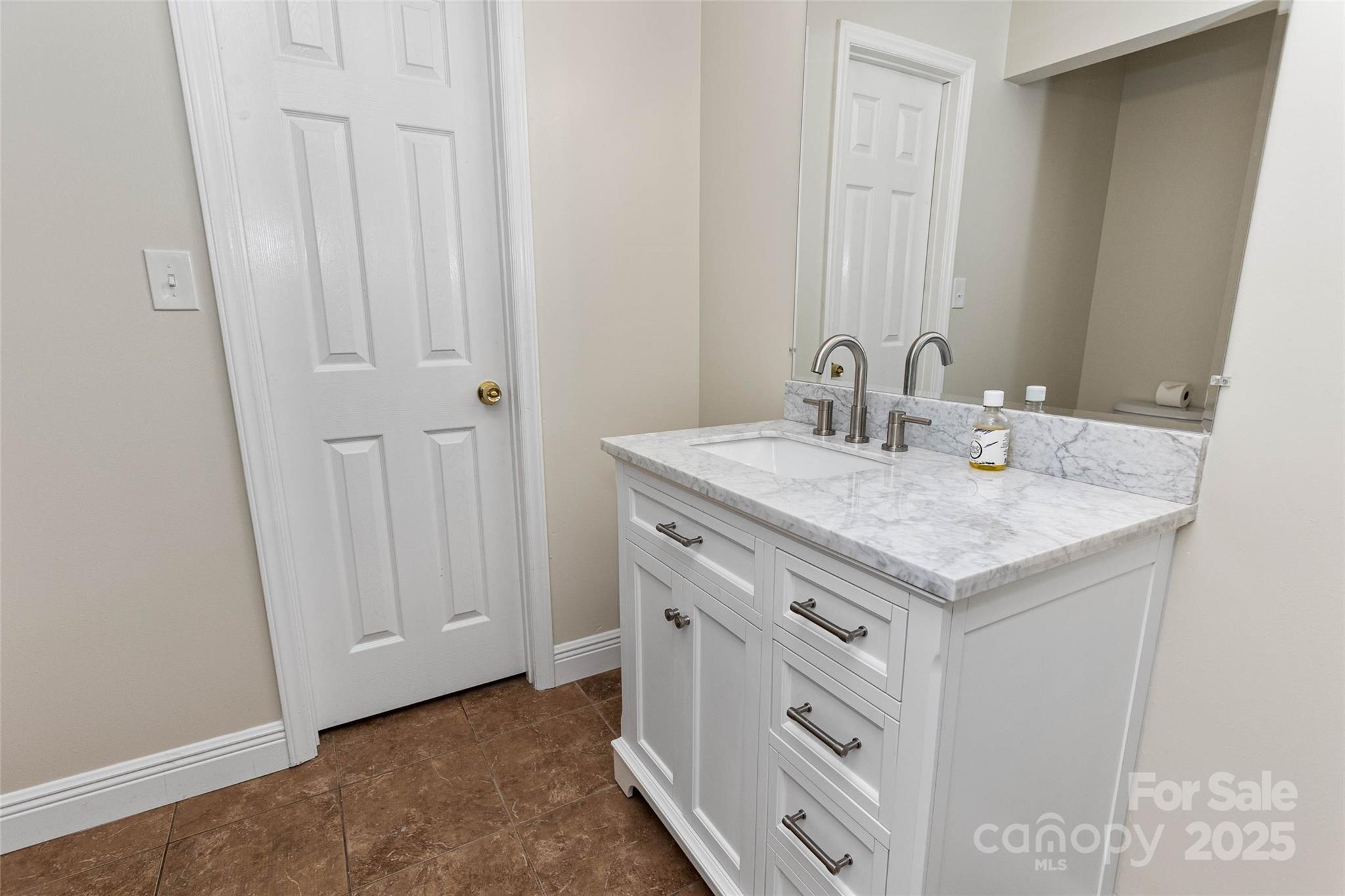 233 Youngs Cove Road Candler, NC 28715 - Photo 14 of 47 a bathroom with a sink and a mirror
