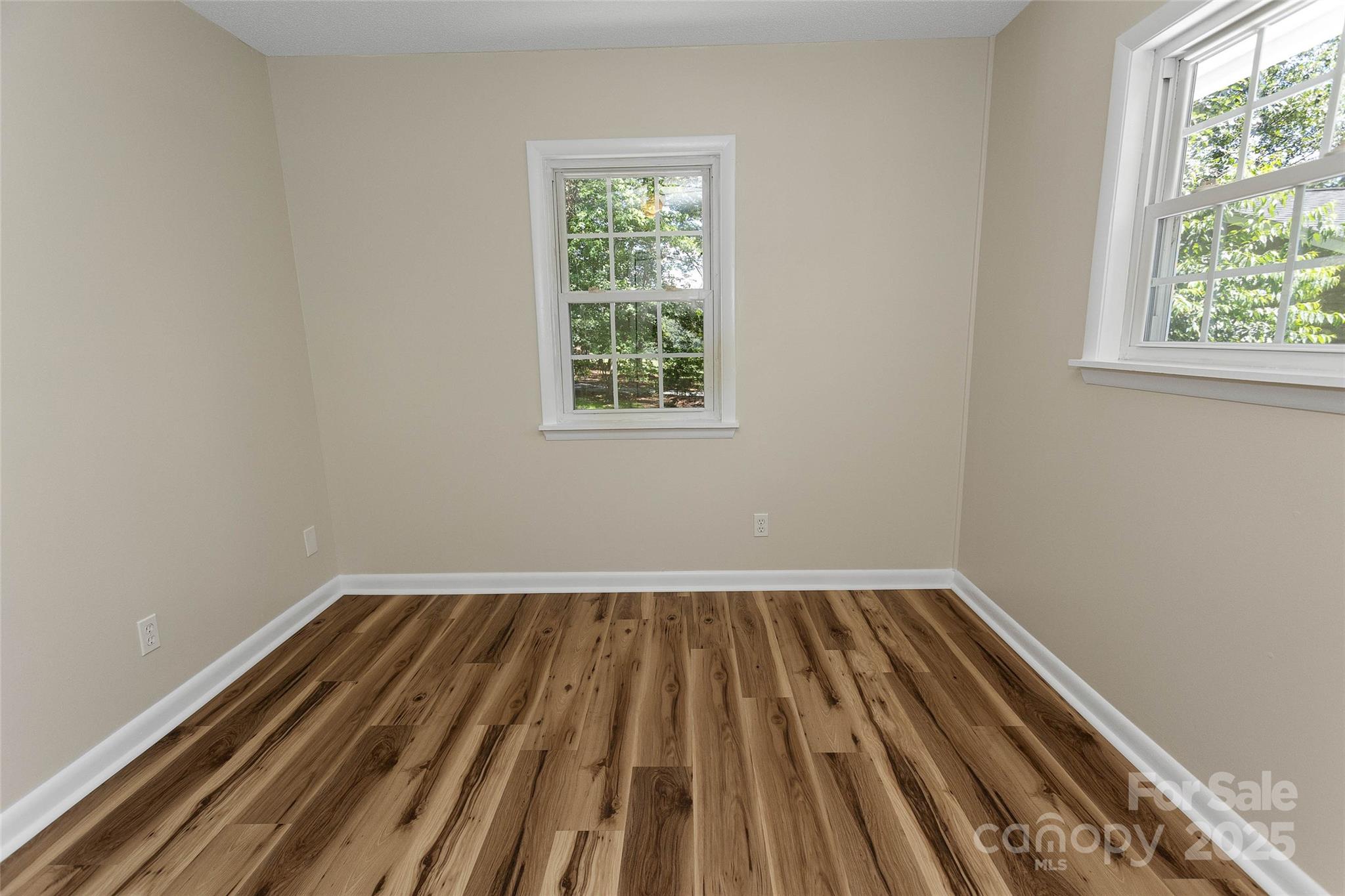 233 Youngs Cove Road Candler, NC 28715 - Photo 17 of 47 an empty room with wooden floor and windows