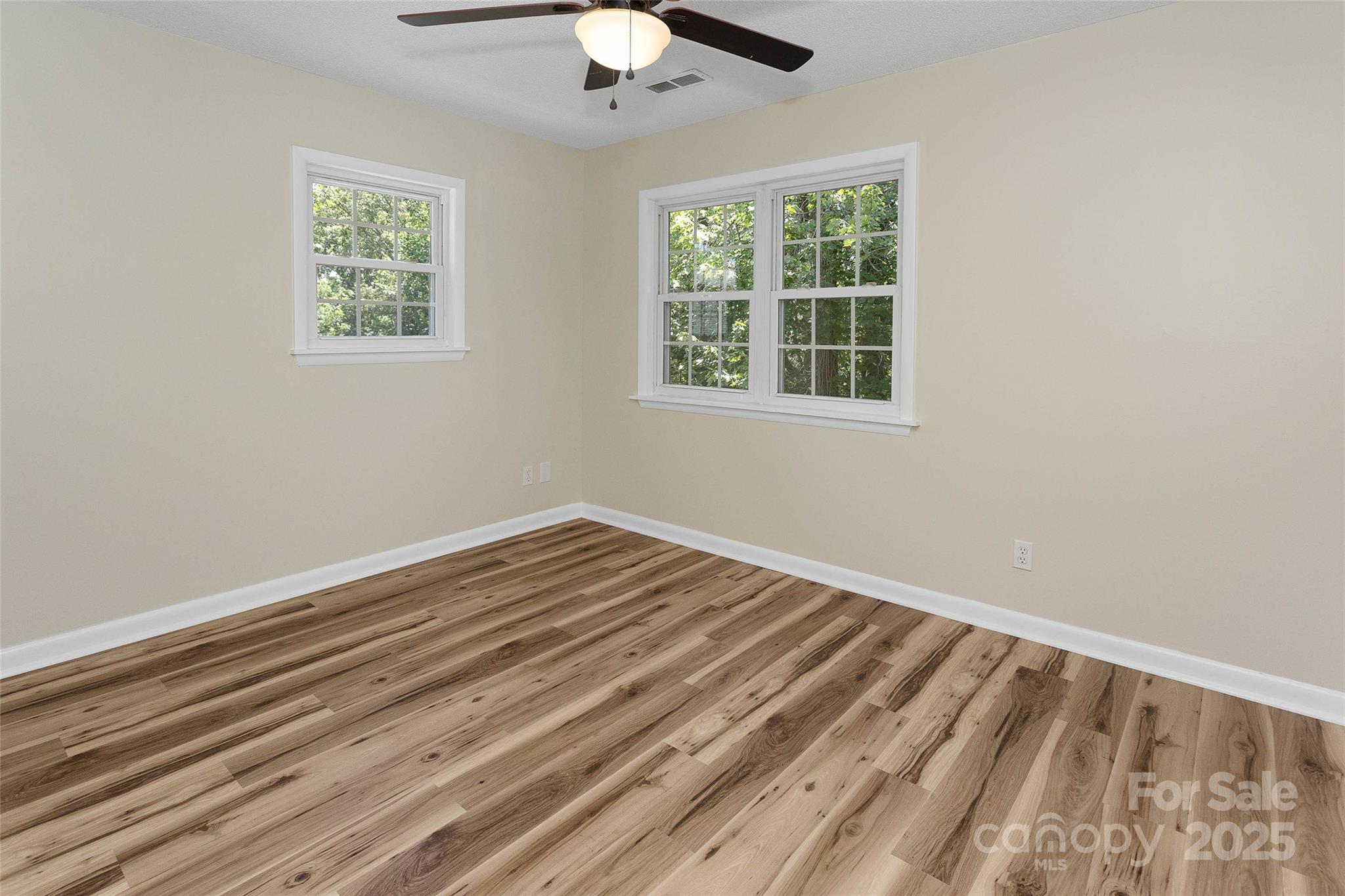 233 Youngs Cove Road Candler, NC 28715 - Photo 22 of 47 wooden floor in an empty room with a window