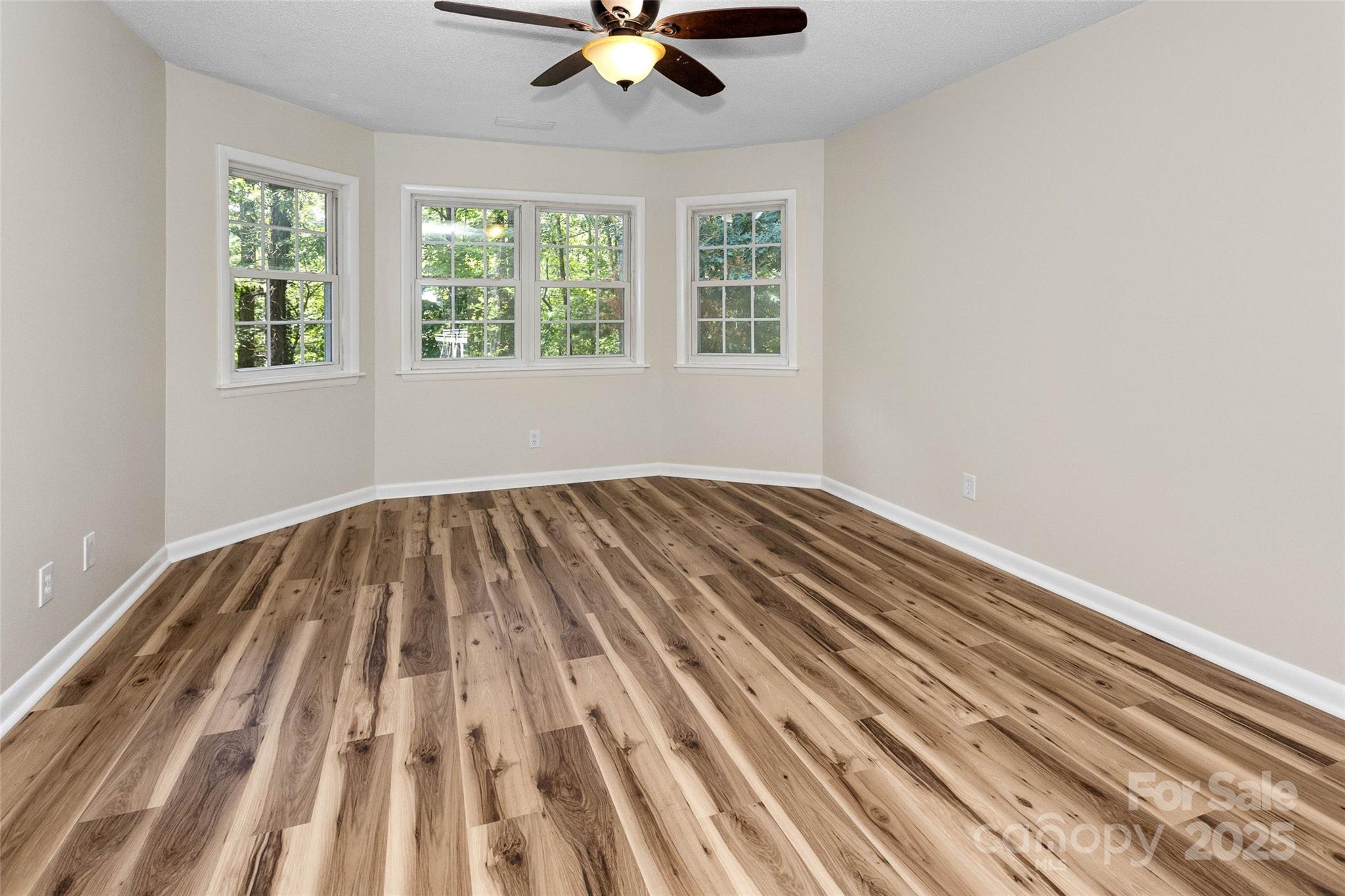 233 Youngs Cove Road Candler, NC 28715 - Photo 23 of 47 wooden floor in a room next to a window
