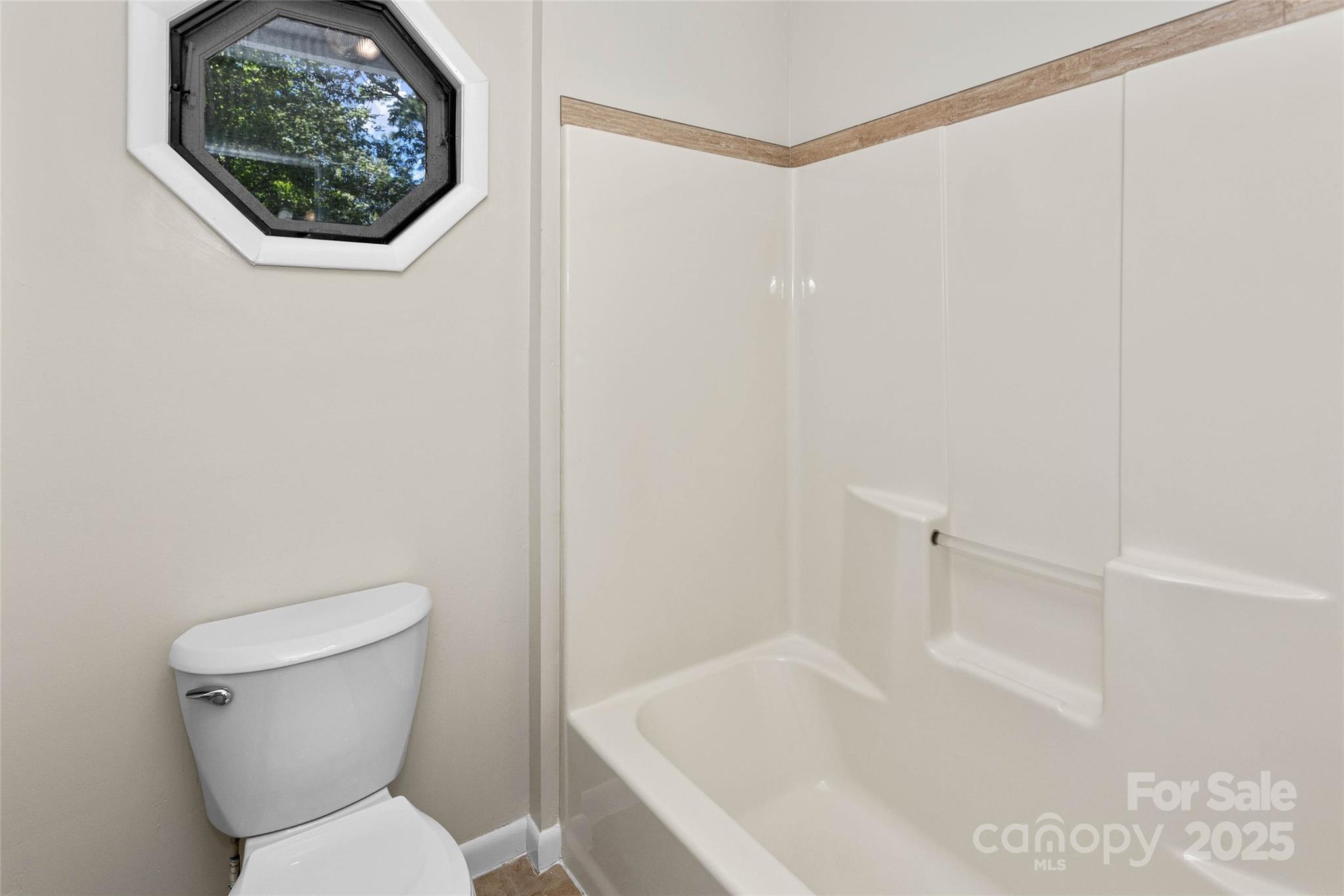 233 Youngs Cove Road Candler, NC 28715 - Photo 26 of 47 a white toilet sitting next to a bath tub