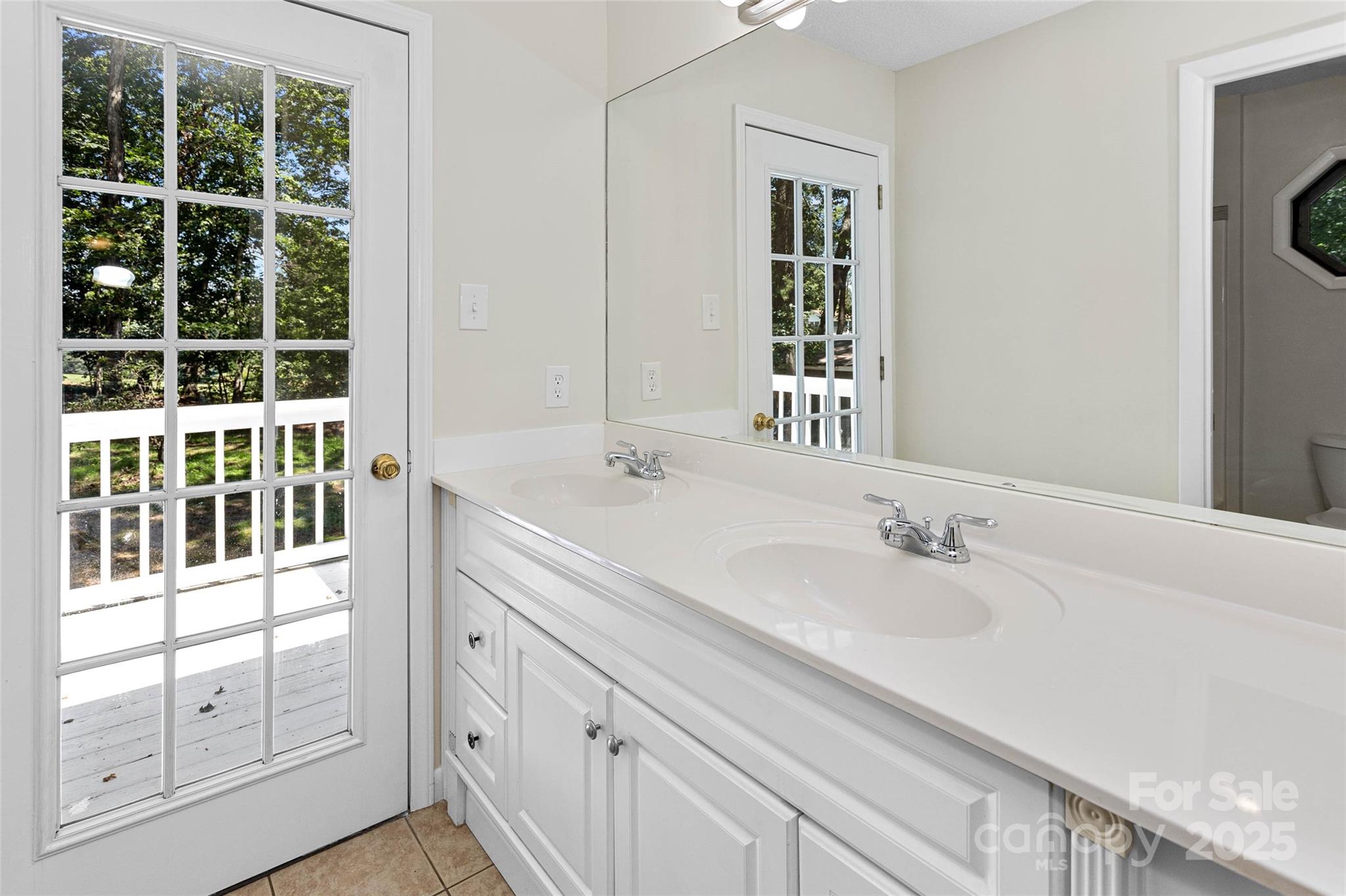233 Youngs Cove Road Candler, NC 28715 - Photo 27 of 47 a bathroom with a double vanity sink and mirror