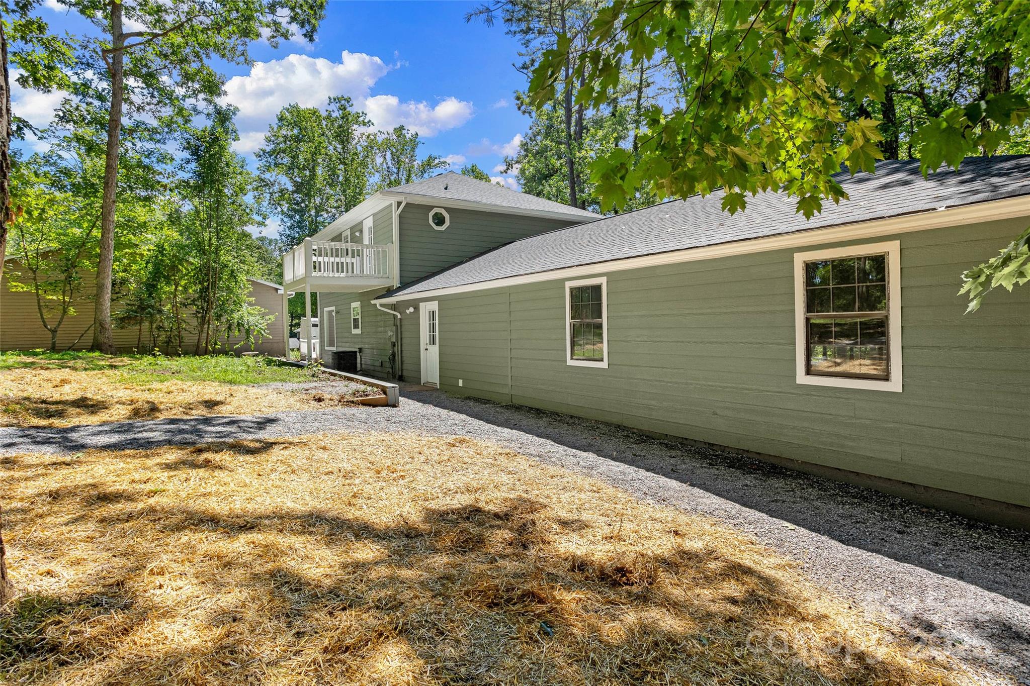 233 Youngs Cove Road Candler, NC 28715 - Photo 42 of 47 a backyard of a house with large trees and wooden fence