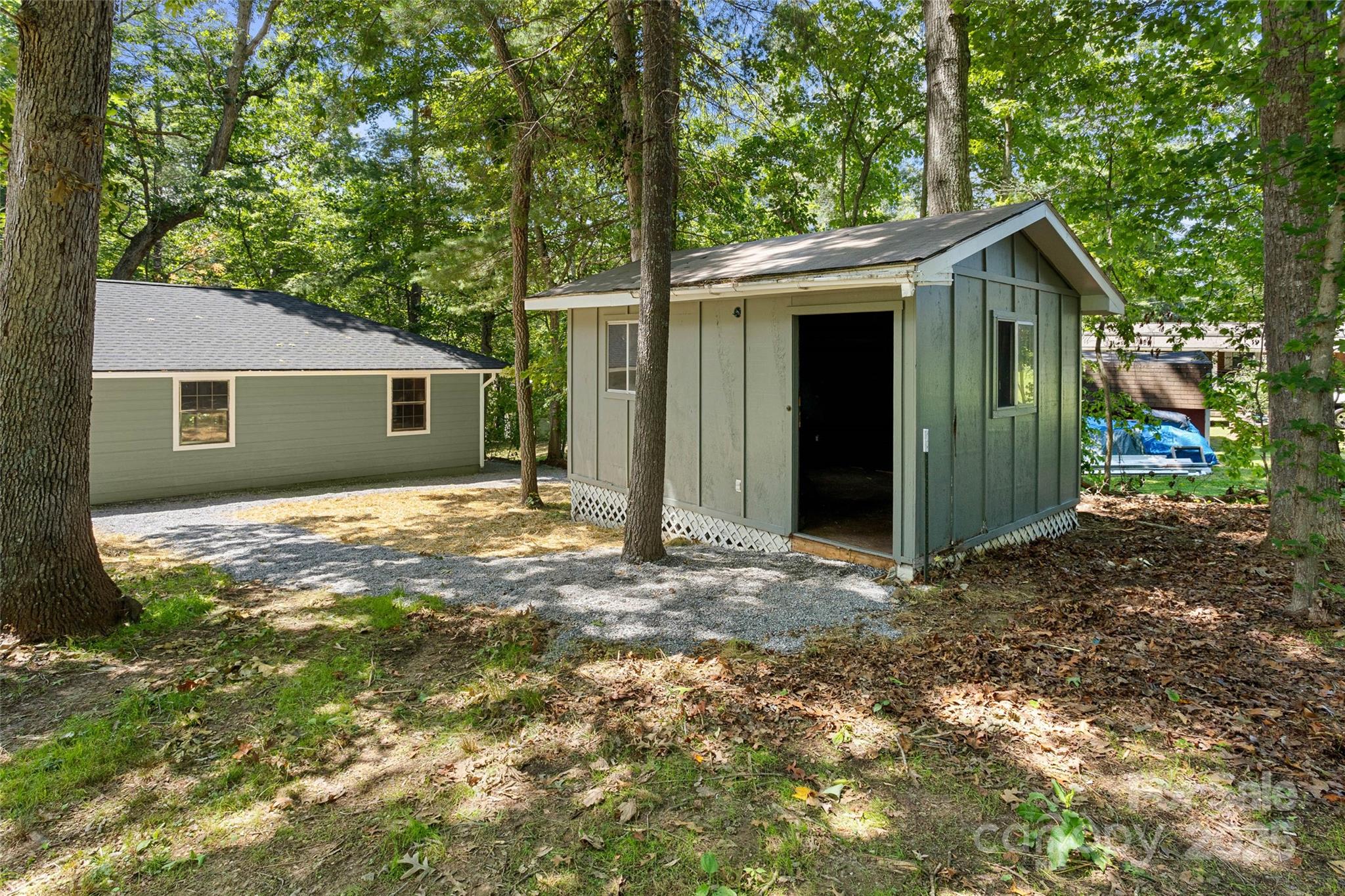 233 Youngs Cove Road Candler, NC 28715 - Photo 43 of 47 a view of a house with a yard and large tree