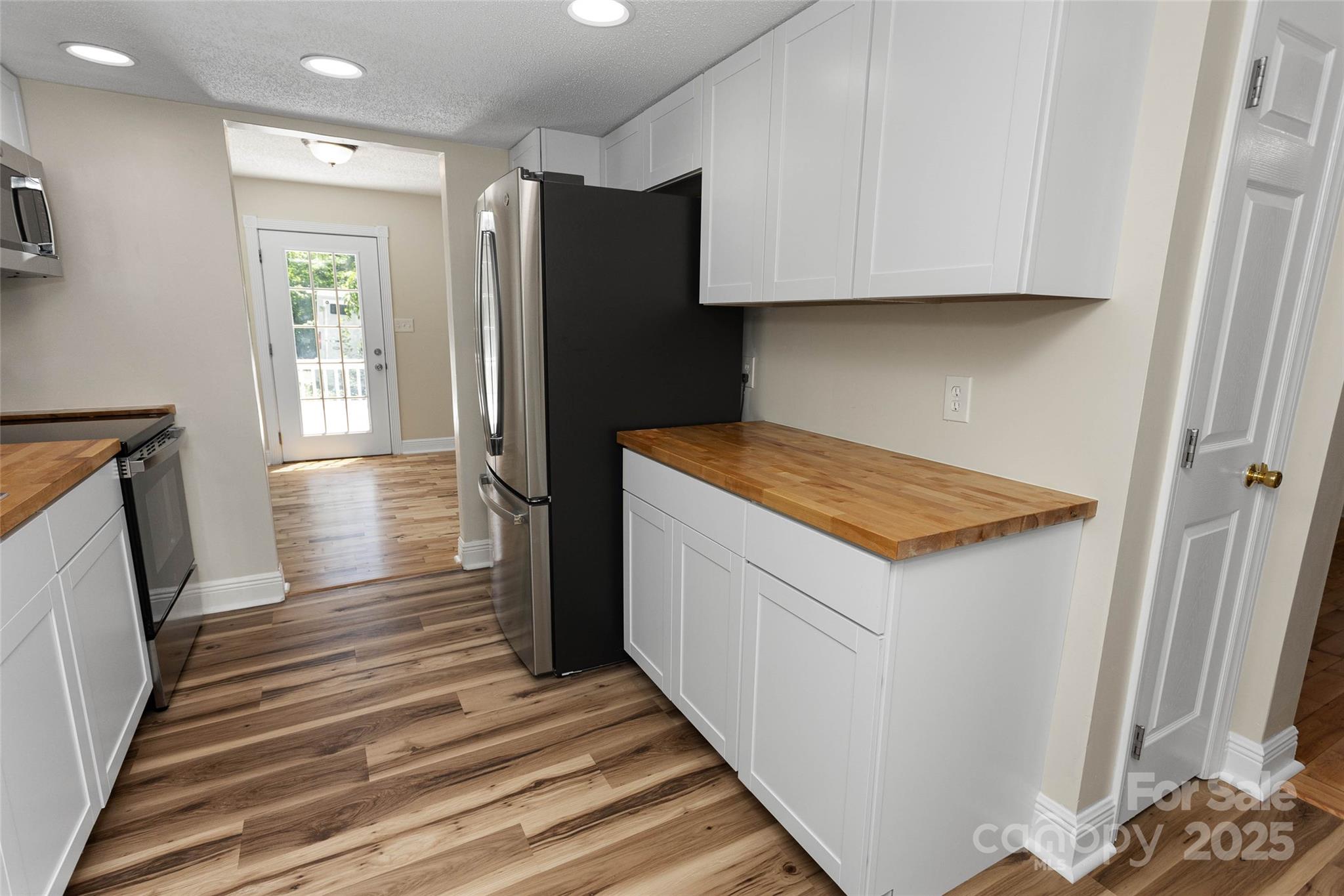 233 Youngs Cove Road Candler, NC 28715 - Photo 7 of 47 a kitchen with a refrigerator and a stove
