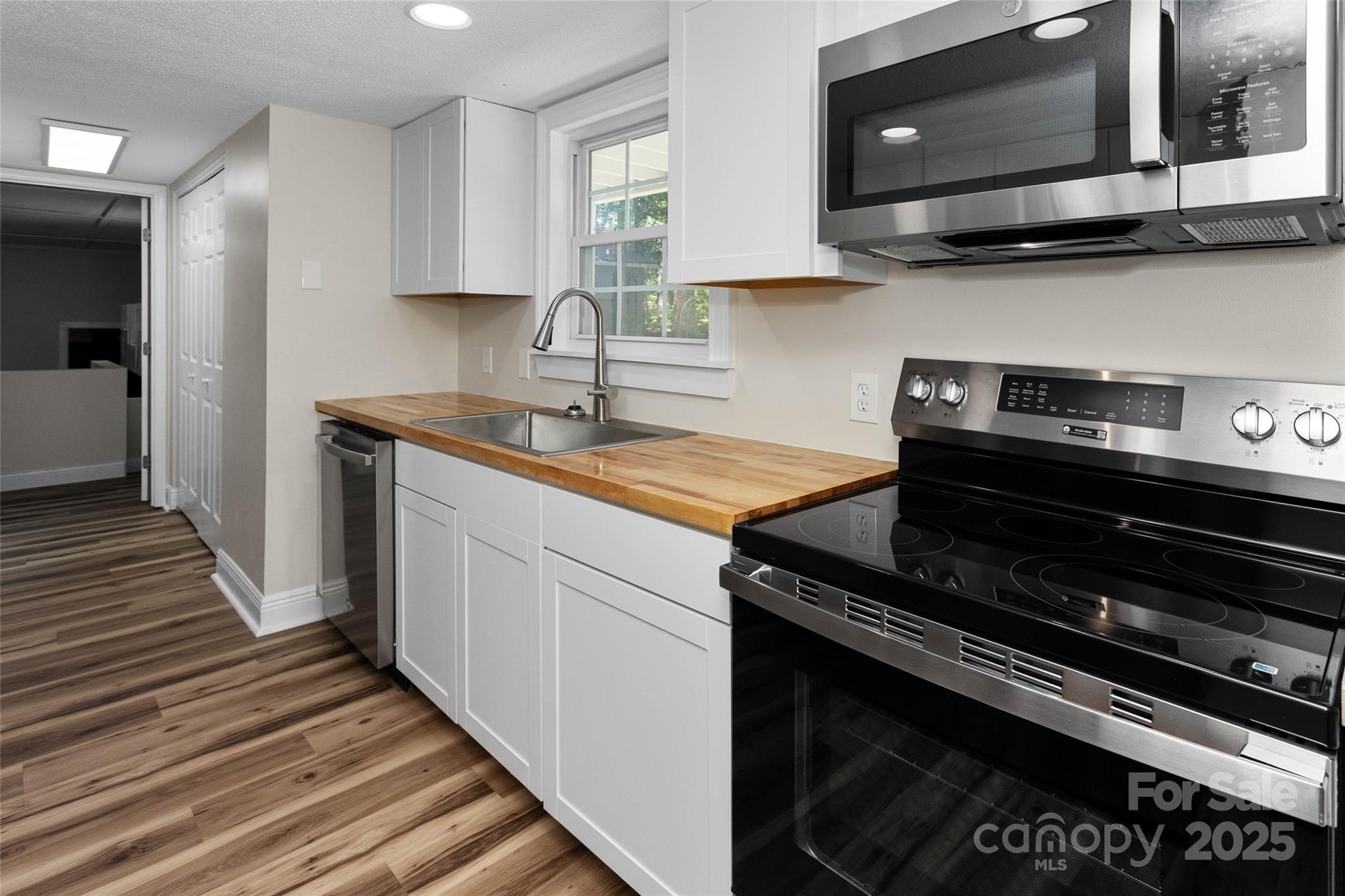 233 Youngs Cove Road Candler, NC 28715 - Photo 8 of 47 a kitchen with a stove and a microwave