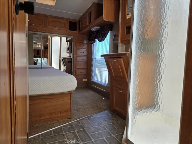 a bedroom with a bed and a mirror