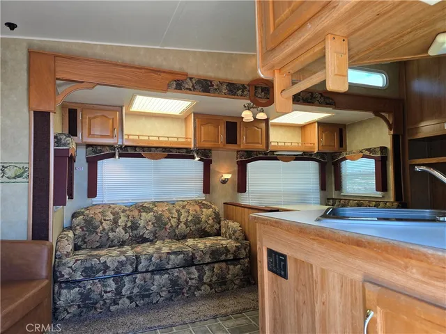 a view of a kitchen with a sink and a refrigerator