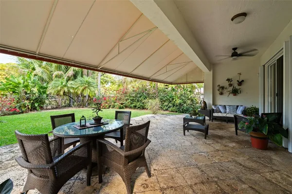 a view of an outdoor dining space with furniture and garden