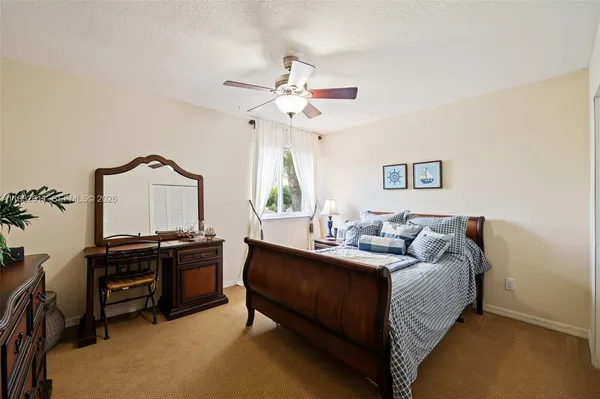 a bedroom with bed furniture and a window