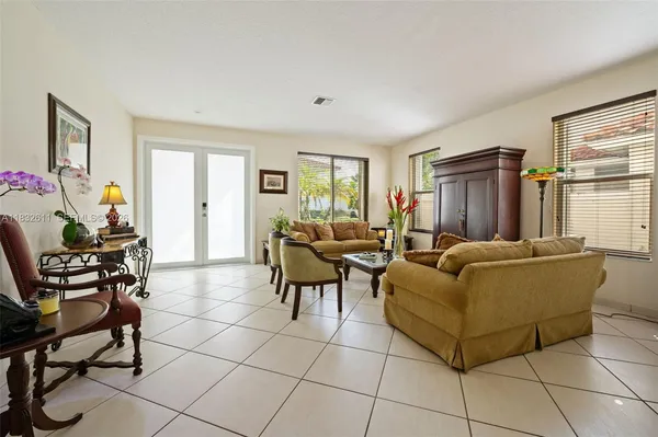 a living room with furniture a dining table and a window