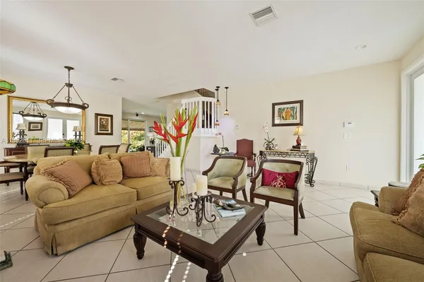 a living room with furniture a rug and a wall painting
