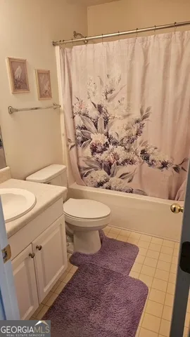 a white toilet sitting next to a bathroom sink