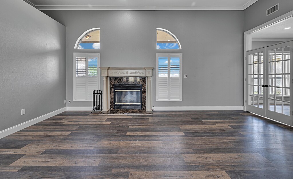 265 Wade Road Eddy, TX 76524 - Photo 11 of 71 a view of empty room with fireplace and wooden floor