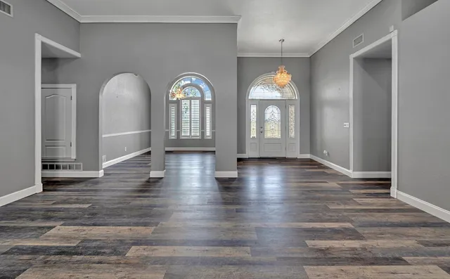 a kitchen with stainless steel appliances a sink cabinets and wooden floor