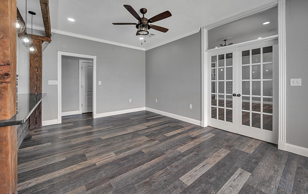 265 Wade Road Eddy, TX 76524 - Photo 19 of 71 a view of a livingroom with wooden floor and a ceiling fan