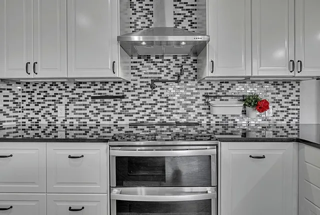 a view of a lake with a big yard and potted plants