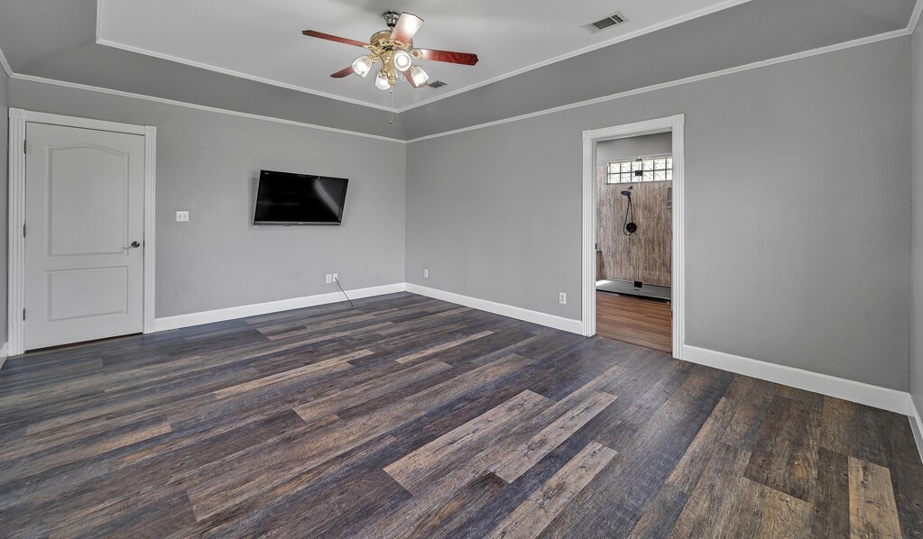 265 Wade Road Eddy, TX 76524 - Photo 33 of 71 a view of empty room with wooden floor and ceiling fan