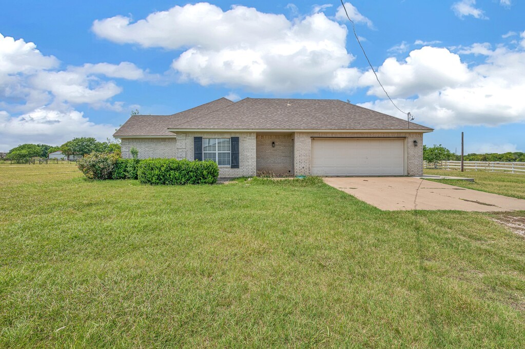 265 Wade Road Eddy, TX 76524 - Photo 63 of 71 a view of a house with a yard and potted plants