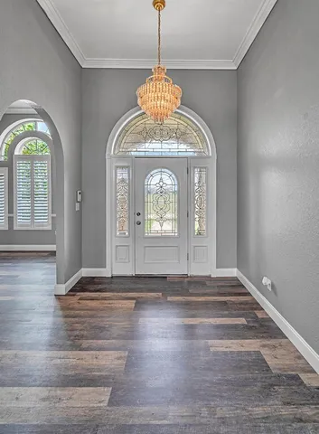 a room with walk in closet and wooden floor