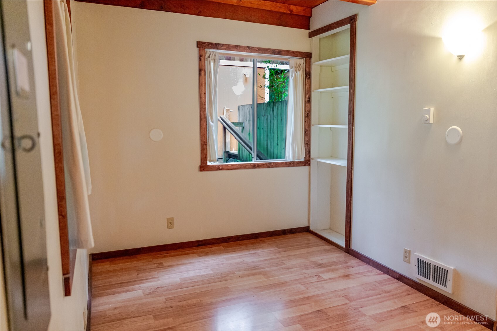 4533 South Discovery Road Port Townsend, WA 98368 - Photo 15 of 32 a view of an empty room with wooden floor and a window