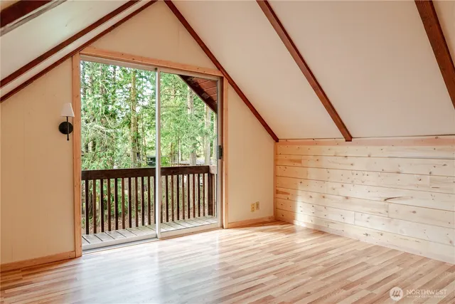 a view of a porch with wooden floor and fence