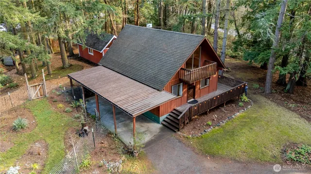 an aerial view of a house with table and chairs under an umbrella