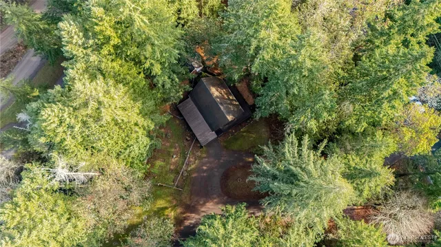 a view of house with backyard and sitting area