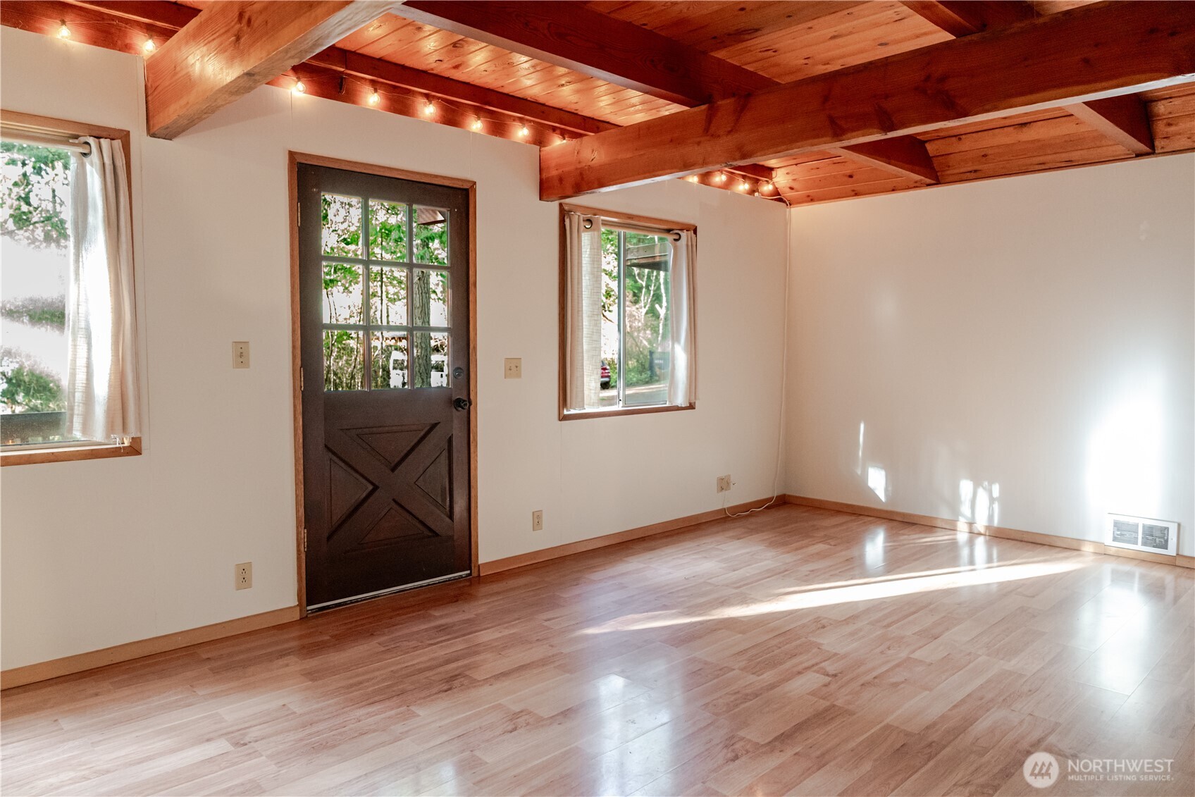 4533 South Discovery Road Port Townsend, WA 98368 - Photo 4 of 32 an empty room with wooden floor and windows