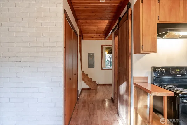 a view of hallway with wooden floor and staircase