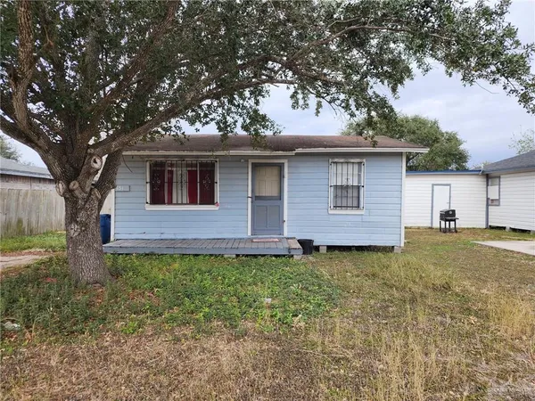 a house that has a tree in front of the house