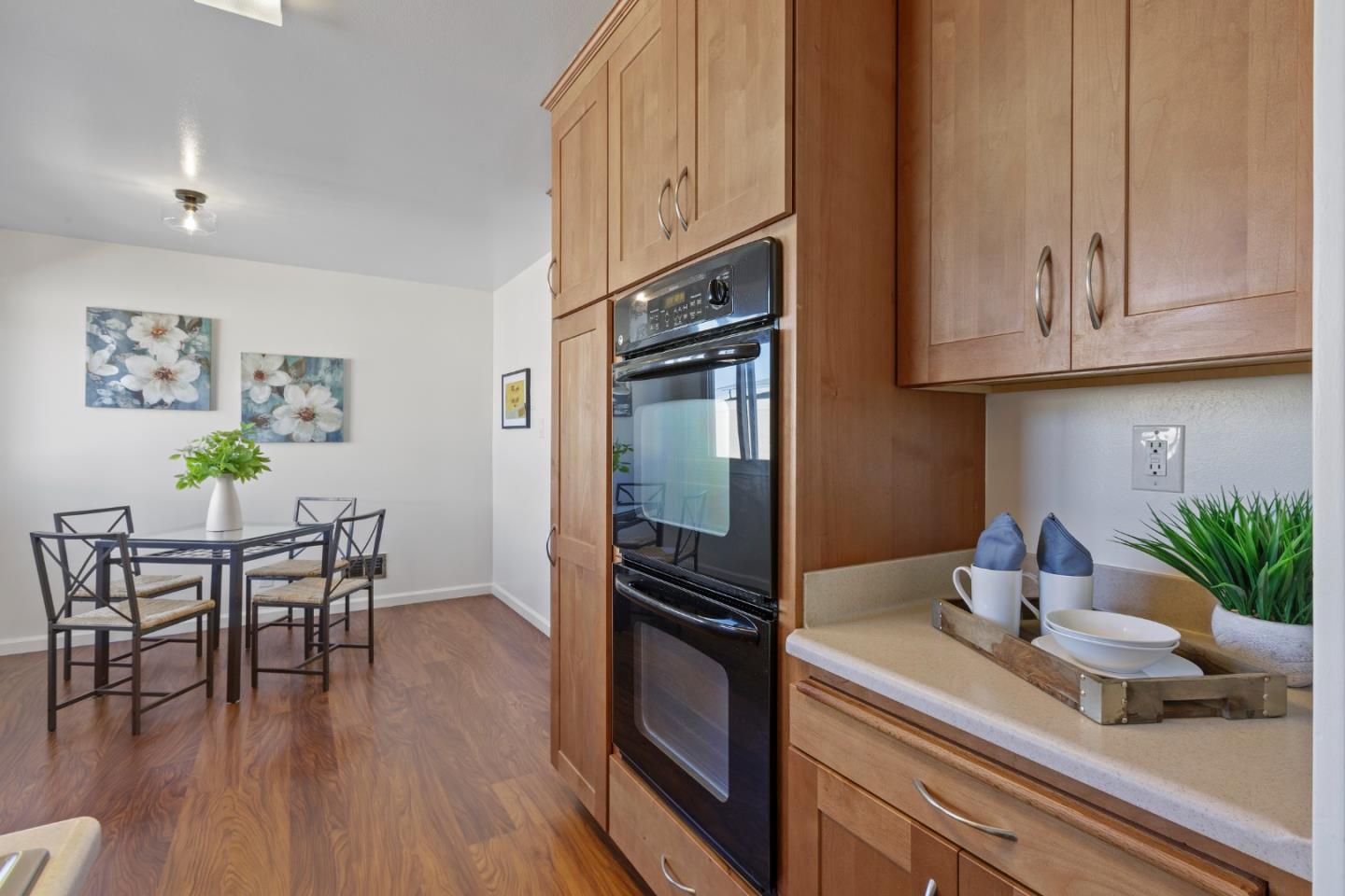 4366 Callan Boulevard Daly City, CA 94015 - Photo 15 of 38 a kitchen with granite countertop stainless steel appliances dining table and wooden floor