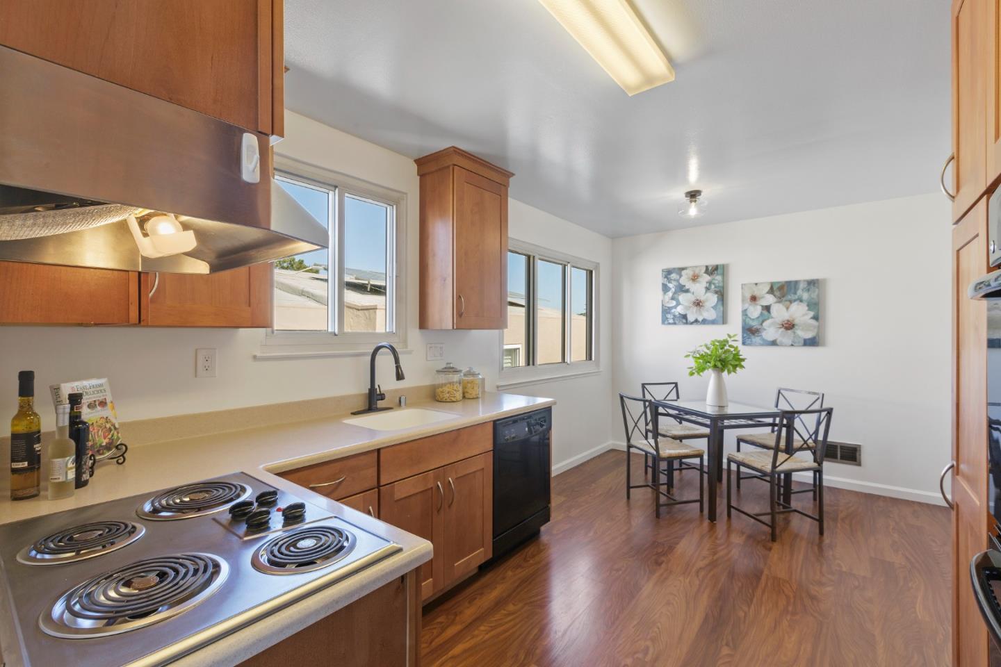 4366 Callan Boulevard Daly City, CA 94015 - Photo 16 of 38 a kitchen with a table chairs stove and wooden floor