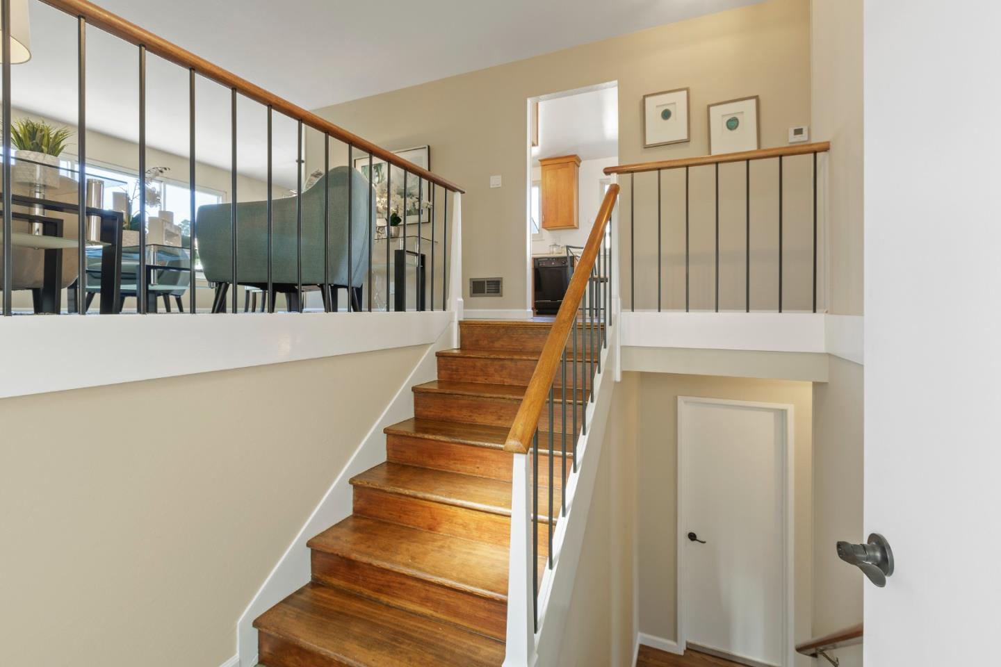 4366 Callan Boulevard Daly City, CA 94015 - Photo 4 of 38 a view of staircase with lots of frames on wall and a large window
