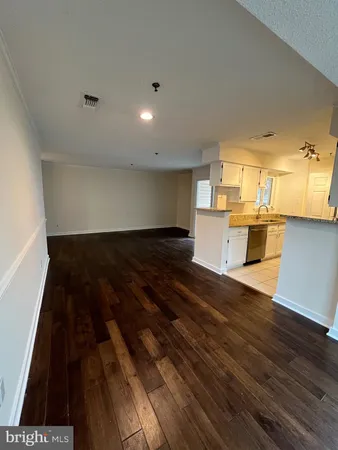 a view of a kitchen with wooden floor and a sink