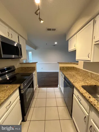 a kitchen with a sink a stove and a microwave