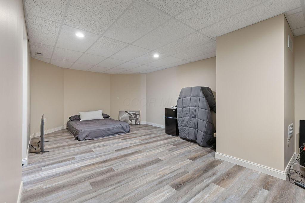 2570 Jewett Road Powell, OH 43065 - Photo 65 of 104 • New luxury vinyl plank flooring ~ 2019/2020 • Ivory painted walls • Can lighting • Acoustic ceiling tiles