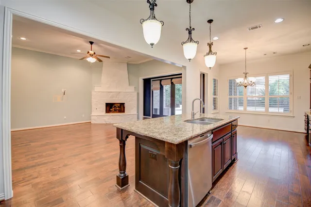 a kitchen with a counter space and wooden floor