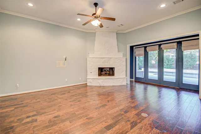 a view of an empty room with a fireplace and a window