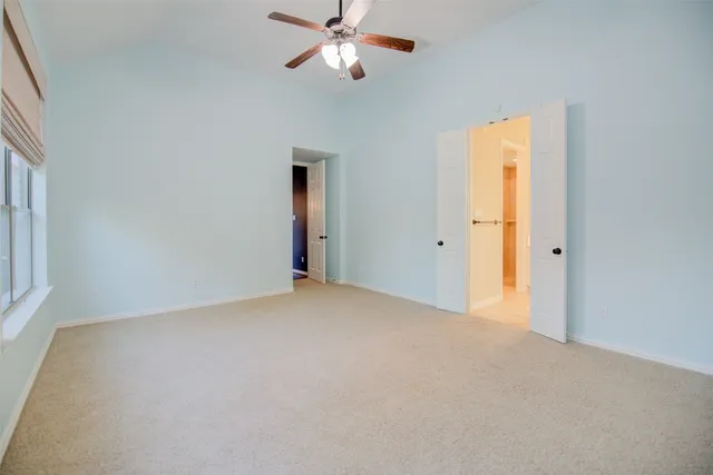 a view of empty room with ceiling fan