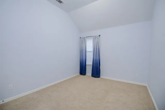 a view of an empty room and a window