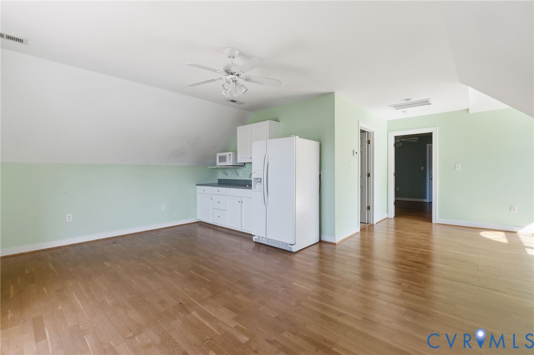 15441 Goshen Road Montpelier, VA 23192 - Photo 37 of 47 an empty room with wooden floor and ceiling fan