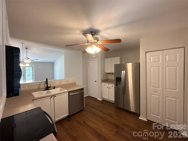 a kitchen with a sink a refrigerator and a stove