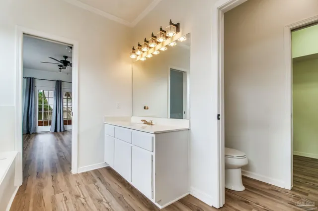 a bathroom with a sink and mirror with toilet