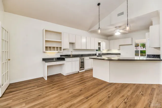 a kitchen with stainless steel appliances granite countertop a sink a stove and a refrigerator