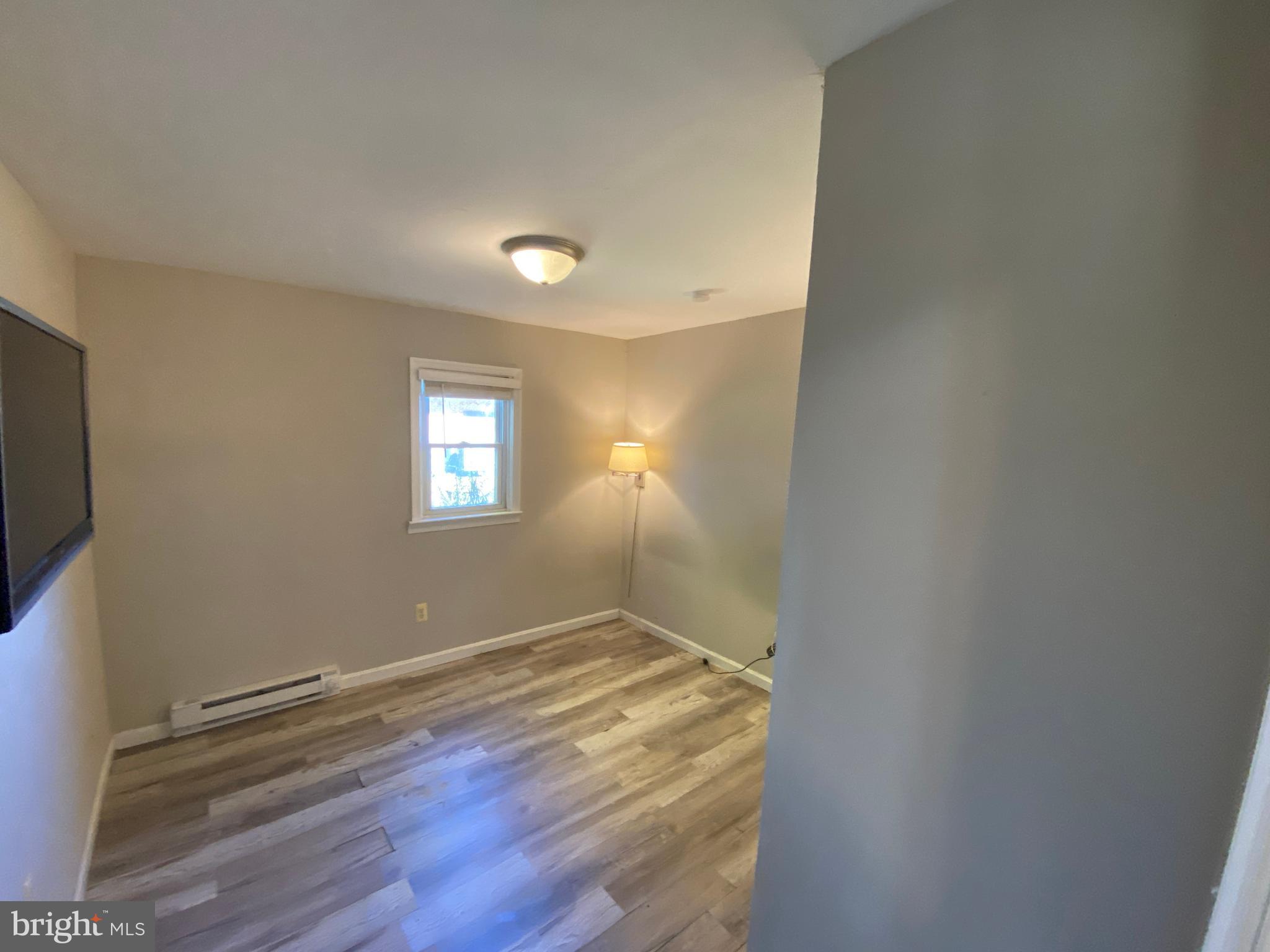 205 North Irving Avenue Colonial Beach, VA 22443 - Photo 11 of 22 a view of empty room with wooden floor and fan