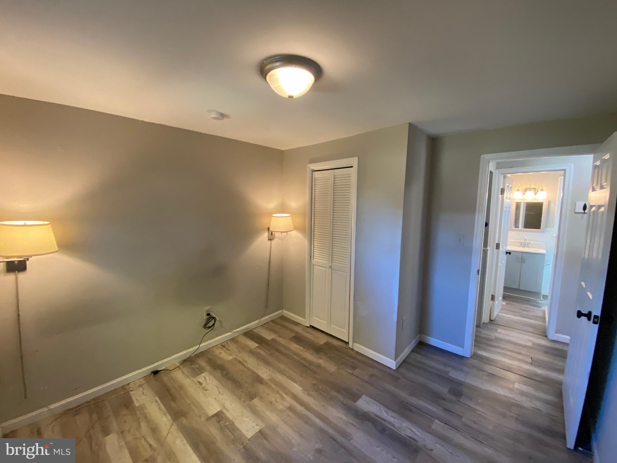 205 North Irving Avenue Colonial Beach, VA 22443 - Photo 12 of 22 a view of a room with wooden floor and bathroom
