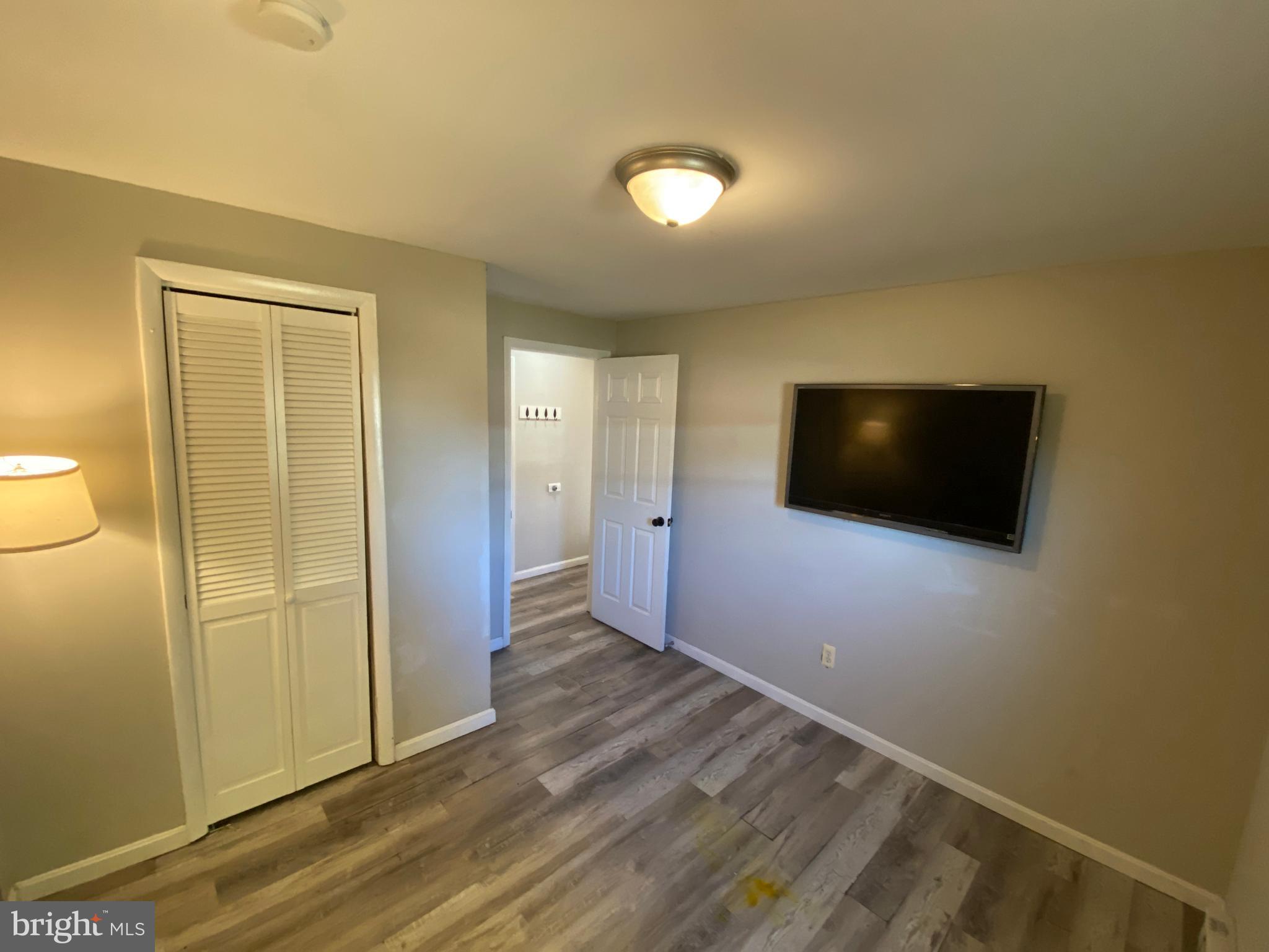205 North Irving Avenue Colonial Beach, VA 22443 - Photo 14 of 22 a view of a livingroom with wooden floor and cabinet
